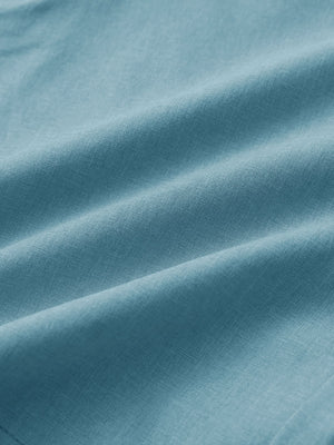 Close-up of blue light heather performance golf shorts fabric showing breathable texture.