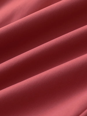 Material detail of Water resistant everyday pants showing smooth finish in cranberry