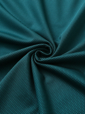 Close-up of turquoise performance ananas jacquard polo fabric showing refined texture.