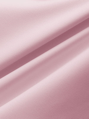 Close-up of pink water resistant golf shorts fabric showing durable weave and protective coating.