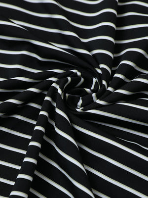 Close-up fabric view of youth performance golf polos, smooth texture with breathable black/white stripe finish