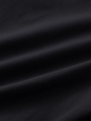 Close-up of black water resistant everyday pants fabric showing durable texture and protective finish.