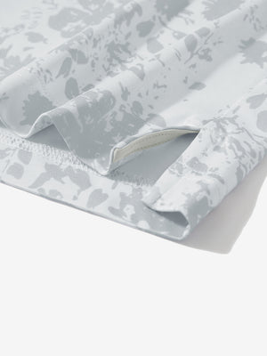 Detail: hem slit of grey splatter stretch printed collarless henley golf shirts