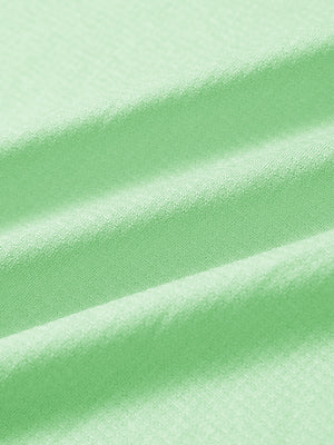 Close-up of light green melange moisture wicking quarter zip pullover fabric texture
