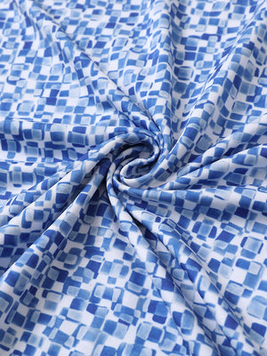 Close-up of blue white mosaic performance jersey print polo fabric texture.