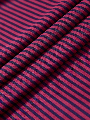 Texture close-up of Kids stripe golf polos with soft fabric and bright maroon stripe stripes