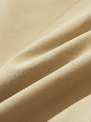 Close-up of khaki boys lightweight dry fit flat front golf shorts fabric texture.
