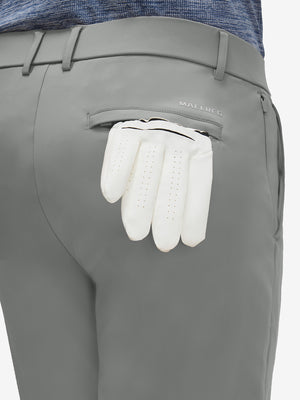 Detail view of back pocket on iron grey flat front golf joggers pants with belt loops