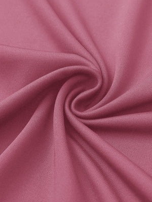 Close-up of pink lemonade women's performance solid polo fabric texture.