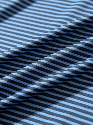 Texture close-up of Kids stripe golf polos with soft fabric and bright blue denim stripe stripes