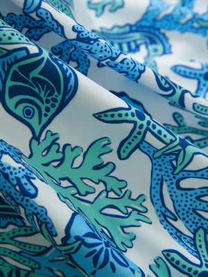 Close-up of sea turtle performance print boys golf polo, showcasing texture and print details.
