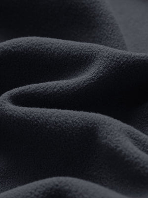 Close-up fabric detail of golf fleece winter puffer jackets, quilted texture and warm feel in black