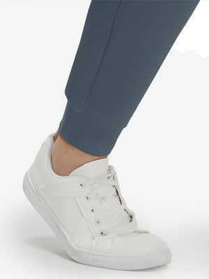 Detail view of hem on grey blue flat front golf joggers pants with belt loops