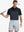 Half-body front shot holding golf club in BLACKDARK GREY Premium Performance Polo