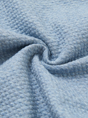 Close-up fabric detail of soft sweatpants with 4 zipper pockets, smooth texture and cozy blue heather feel