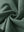 Fabric close-up of forest green boys stretch fleece lined casual golf pants, soft stretch fabric with warm fleece lining.