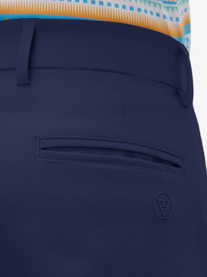 Close-up of the back pocket detail on the dark blue youth water resistant cotton blend golf pants, emphasizing storage