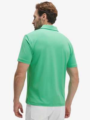 Back half-body view of a model wearing the irland green everyday classic solid polo, highlighting the tailored rear fit