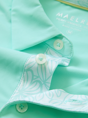 Detail of the collar opening on the aqua blue everyday classic solid polo, emphasizing the structured neckline design