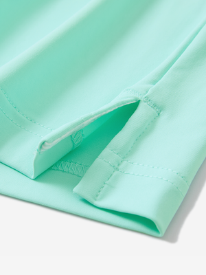 Detail of the side vent hem on the aqua blue everyday classic solid polo, showing the split hem feature