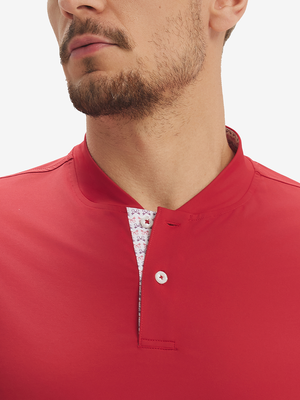 Close-up of model in red moisture-wicking short sleeve henley shirt, nose to chest view.