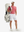 Full-body front view: model in brick red moisture-wicking short sleeve henley shirt carrying golf bag.
