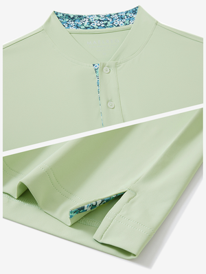 Detail of light green moisture-wicking short sleeve henley shirt showing collar and hem vent construction.