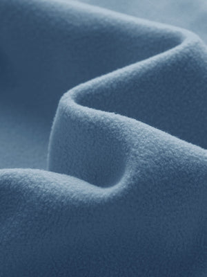 Close-up fabric detail of golf fleece winter puffer jackets, quilted texture and warm feel in shadow blue