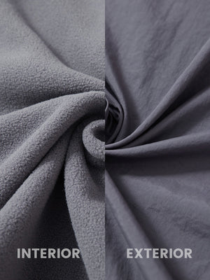 Close-up of inside and outside fabric of dark grey windproof fleece reversible golf vest.