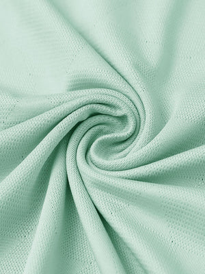 Close-up of mint green modern texture stylish polo fabric showing surface detail.